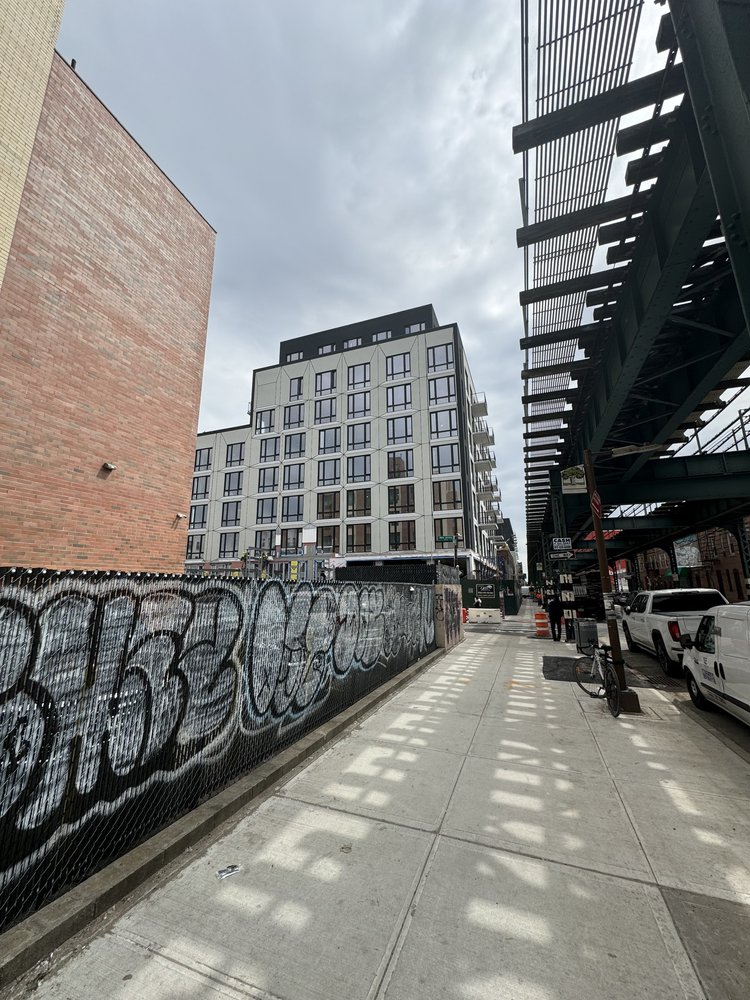 Corner development on Fulton Street, right up against the above ground J Train. 
